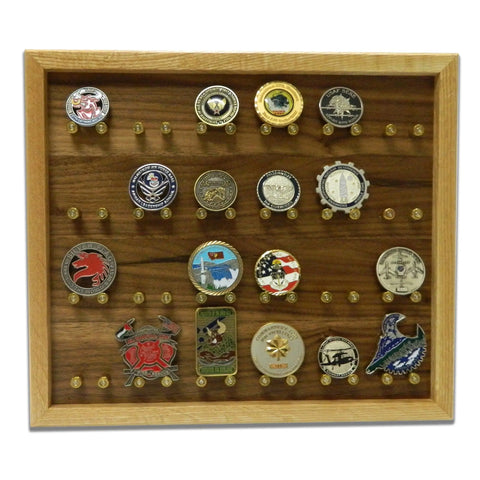 The ORIGINAL Brass Casing Challenge Coin Display - Medium by Legacies of America Woodworking Company features a glass front, light wood frame, dark wood background, and showcases 20 challenge coins on brass pegs. Proudly American made.
