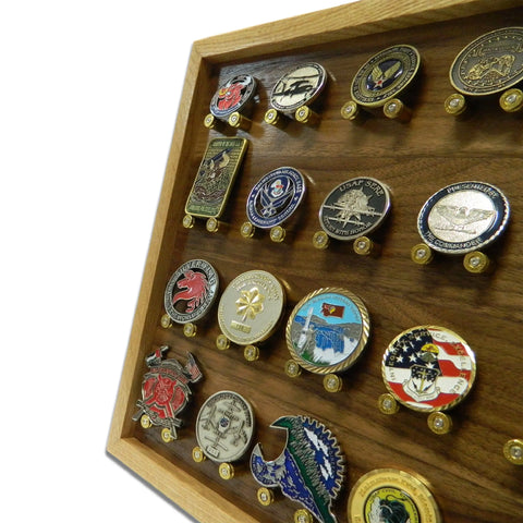 The ORIGINAL Brass Casing Challenge Coin Display - Medium by Legacies of America Woodworking Company holds American Made challenge coins upright on pegs in a wooden case with a white background.
