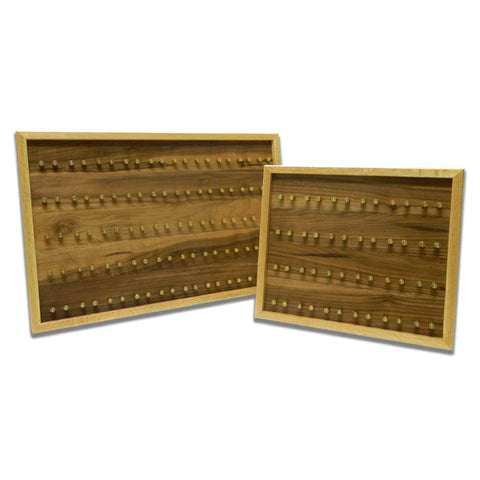 The ORIGINAL Brass Casing Challenge Coin Display - Medium by Legacies of America Woodworking Company features two angled, differently sized wooden boards with rows of brass pegs, light wood frames, and is proudly American made—perfect for displaying challenge coins.
