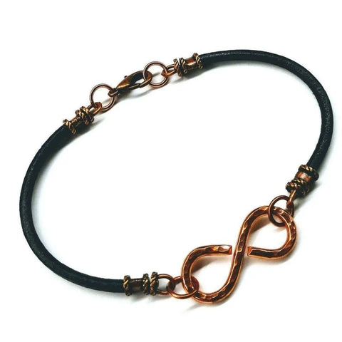 The Masculine Sturdy Copper Swivel Infinity Bracelet by Alexa Martha Designs features a gold infinity symbol charm and gold hardware, shown on a white background.