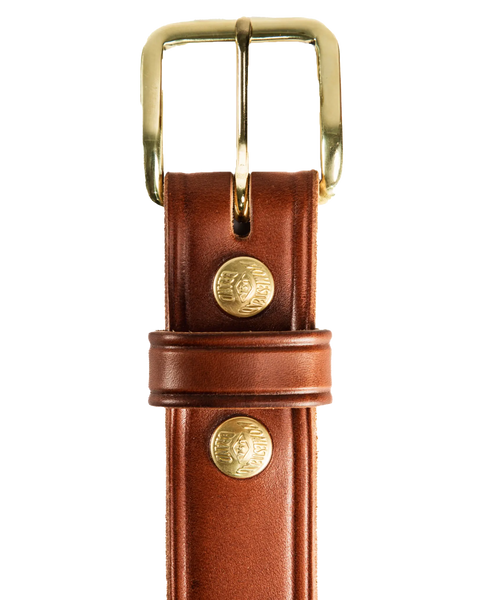 Close-up of the Homestead Brand Mens Americana Belt No. 1507, crafted from full grain leather with a gold buckle and two embossed gold rivets, set against a white background. Made in USA.