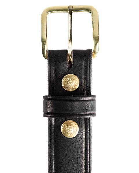 Close-up of the Homestead Brand Mens Americana Belt No. 1507, made from full grain leather with a shiny gold buckle and rivets. “USA Crafted” is stamped on it, and the loop with logo stands out against a white background. Proudly made in USA.