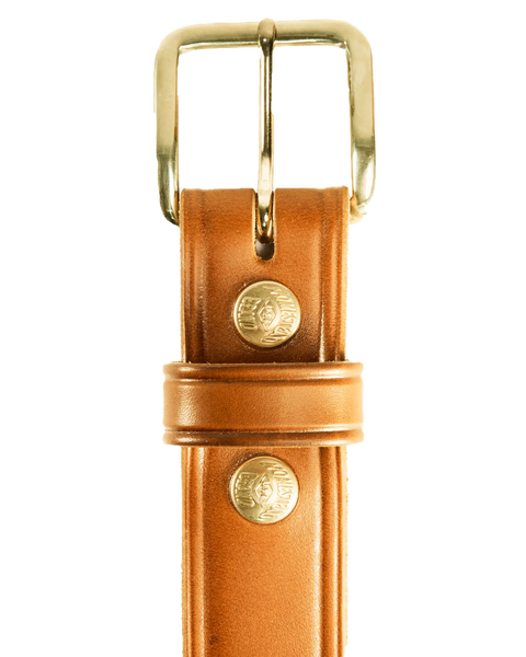 Close-up of Homestead Brand Mens Americana Belt No. 1507, crafted in the USA from full grain leather with a gold buckle and two gold rivets embossed with text, shown on a white background.