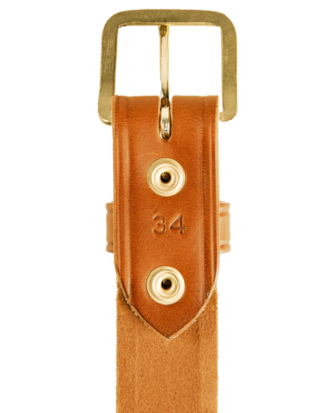 Close-up of a Homestead Brand Mens Americana Belt No. 1507, made in USA with tan full grain leather, gold buckle and two gold rivets. The number 34 is stamped below the buckle against a white background.