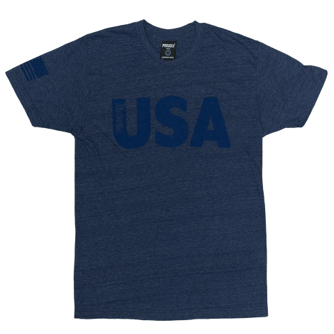 The Proudly USA - Mens TriBlend T-Shirt (Heather Denim) by Proudly USA features bold USA text on the front and a flag graphic on the right sleeve—a soft, comfortable way to show your American pride.