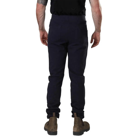 A man wearing Spiritex Saratoga Pants in organic cotton paired with brown boots.