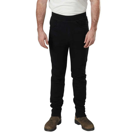 A man wearing a white T-shirt and Spiritex | Sustainable Apparel Saratoga Pants in black stands facing forward with brown shoes, arms relaxed by his sides, against a plain white background.