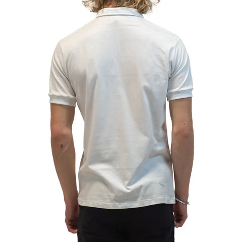 A person with shoulder-length blond hair, seen from the back against a white background, wears the Spiritex | Sustainable Apparel Short Sleeve Mt. Mitchell Collared Shirt in white organic cotton and dark pants.