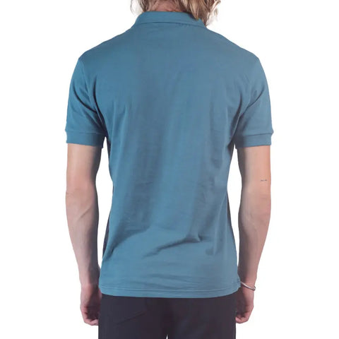 A person with long, light hair is seen from the back wearing the Spiritex Short Sleeve Mt. Mitchell Collared Shirt in teal and black pants against a white background.