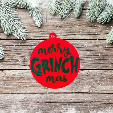 The Merry Grinchmas Christmas Ornament by Chatelet Manufacturing, made in the USA, features “merry GRINCH mas” in green and white and brings festive cheer to any décor. Perfect for holiday decorating!.