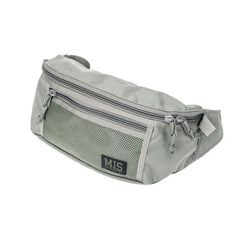 The MIS Mesh Waist Bag - Foliage is a light gray, USA-made waist bag with multiple zippered compartments, a mesh front pocket, logo patch, durable Dupont Cordura Nylon construction, adjustable strap, and a minimalist design.