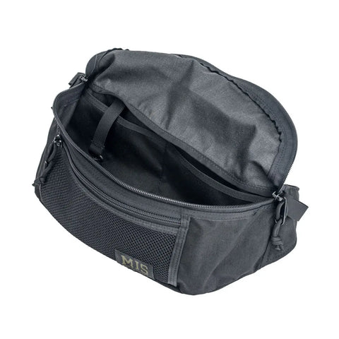 The MIS Mesh Waist Bag - Black features an open main zipper compartment, revealing an inner pocket and a military mesh front with the signature MIS label.