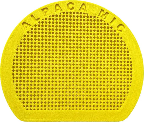 The Extra Front Cap by Alpaca Mic is a round, yellow, textured accessory embossed with ALPACA MIC along the top. A grid of small holes on its surface ensures effective audio isolation for clear sound quality.
