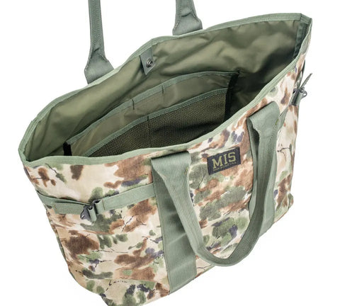 The MIS Multi Tote Bag - Covert Woodland features green handles, interior mesh and fabric pockets, a front MIS patch, and a water-resistant open top showing its spacious interior. Made in the U.S.A.