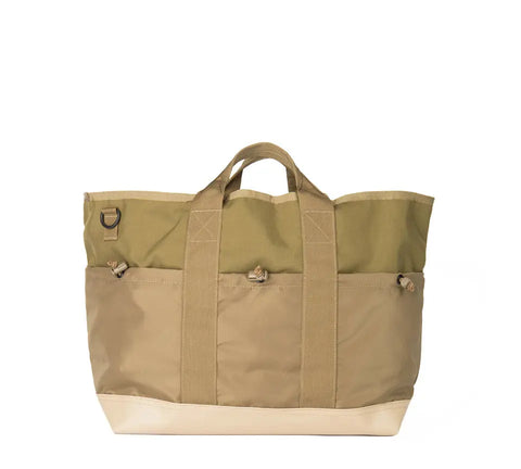 The MIS Multi Pocket Tote Bag - Coyote Tan features durable Cordura nylon in beige and olive green, two handles, exterior pockets, a beige base, and a small metal ring on the upper left, displayed against a white background.