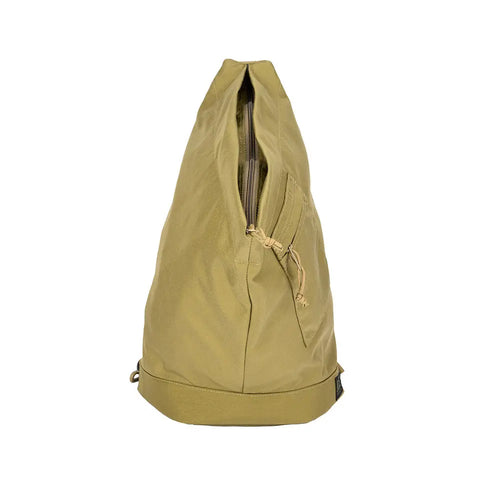 The MIS TA One Shoulder Bag in Coyote Tan stands upright on a white background, showcasing its front zipper pocket and top drawstring closure. Durable, water-resistant Cordura nylon makes it a stylish choice for everyday use.