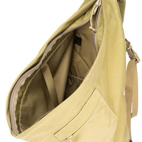 A close-up of the MIS TA One Shoulder Bag in Coyote Tan highlights its spacious main compartment, interior pocket, zipper details, and a partially visible shoulder strap on the right.