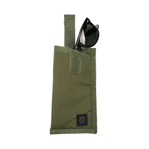 A pair of black sunglasses is partly tucked into an olive green MIS Tactical Key Strap Set pouch with a Velcro strap and a small black MIS MADE IN USA label, set against a white background.