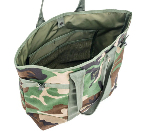 The MIS Multi Tote Bag - Woodland Camo features a spacious main compartment, multiple interior pockets, sturdy handles, and open-top design. Made from durable Cordura Nylon fabric with a green camouflage pattern.