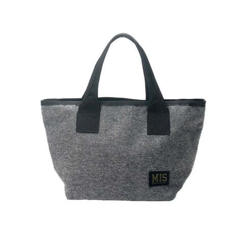 The MIS Mini Tote Bag - Denim Grey features black handles and trim, a small black MIS patch with yellow lettering, and water-resistant Cordura nylon. Made in the USA, it’s shown against a white background.