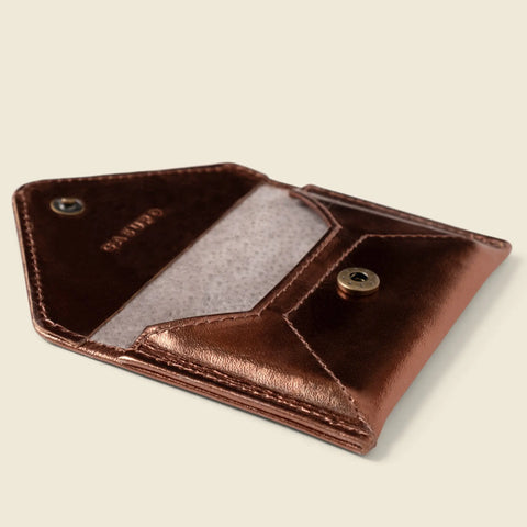 The CASUPO Mini Envelope Wallet With RFID Protection in bronze is shown open, displaying its light interior, snap button closure, and secure RFID protection against a neutral background.