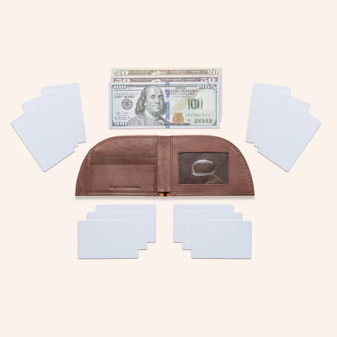 An open Rogue Industries Rogue Front Pocket Wallet – Classic Made in Maine Edition sits empty with blank white cards nearby. Above this RFID-blocking wallet are $20, $50, and $100 U.S. bills on a light background.