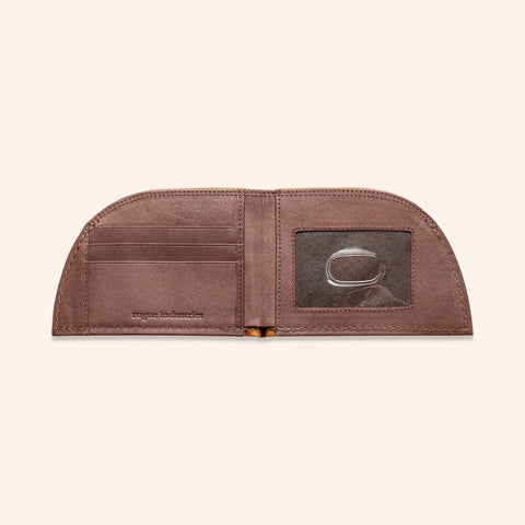 The Rogue Industries Rogue Front Pocket Wallet - Classic Made in Maine Edition is a slim brown premium leather wallet with a curved top, card slots on the left, and a clear ID window with a circular metal object on the right.