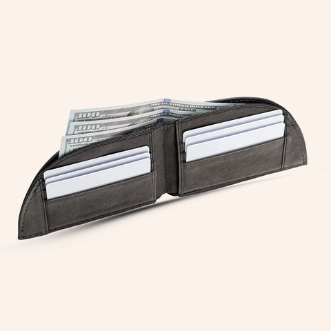 The Rogue Industries Rogue Front Pocket Wallet - Classic Made in Maine Edition, crafted from dark premium leather, is open to show multiple slots with white cards and $100 bills on a light background.