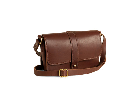 The Urban Southern Lancaster 5-Pocket Crossbody features brown full-grain leather, a flap closure with gold-tone buckle, and an adjustable strap, displayed on a white background for minimalist style.