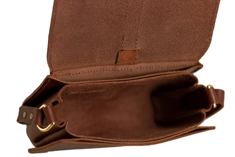 Urban Southern’s Lancaster 5-Pocket Crossbody in full-grain leather features a suede interior, five compartments, and an adjustable strap with gold hardware—ideal for minimalist fashion enthusiasts.