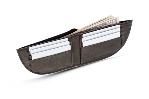 The Nantucket Front Pocket Wallet by Rogue Industries, crafted in black top-grain leather, is open to display multiple card slots with white cards and a bill compartment holding U.S. cash—including a visible $50 bill—against a white background.