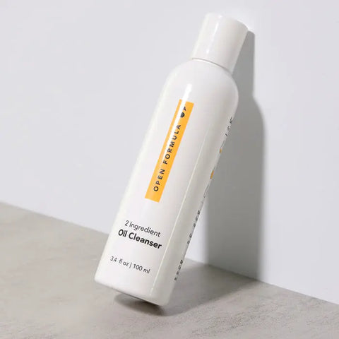 A white Open Formula Oil Cleanser bottle (3.4 fl oz / 100 ml) stands on a light gray surface with a white background—an effective makeup remover and pore-cleansing oil that leaves no oily residue.