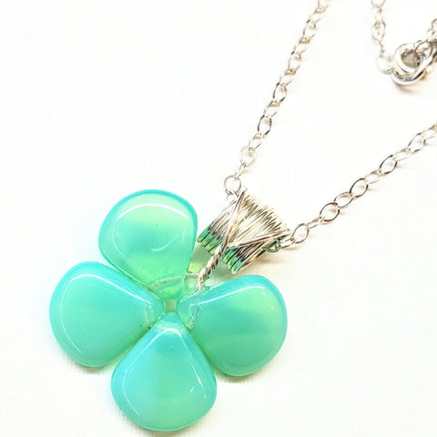 The Alexa Martha Designs Mint Green Beaded Sterling Silver Clover Necklace features a clover pendant with smooth mint green beads, elegantly wrapped in sterling silver wire.