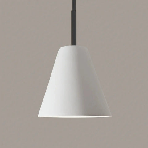 The Strands Mini Pendant by A19 Artisan Lighting features a modern, white, cone-shaped design and hangs from a black cord, handcrafted in California against a light gray backdrop.