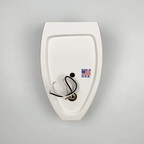A white wall-mounted fixture backplate with exposed wires and a Made in U.S.A. sticker, attached to a light gray wall—part of the Modern USA-Made Wall Lighting – Aruba Sconce by A19 Artisan Lighting, handcrafted in California.