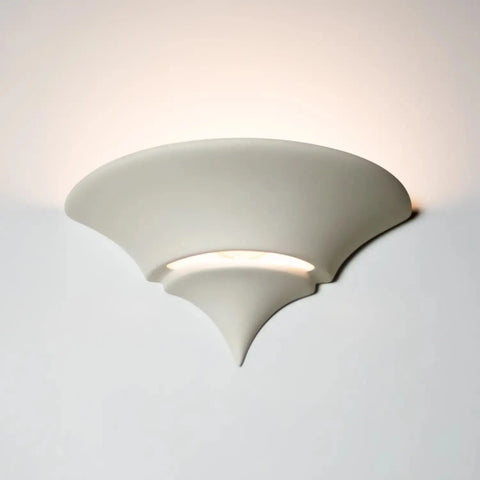 A bell-shaped flush wall light known as the Atlantis Sconce, with an up-and-down light pattern, installed on a wall.