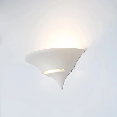 The Atlantis Sconce by A19 Artisan Lighting is a modern, handcrafted wall light made in California, featuring a sculptural white design that casts soft up and down light against any wall.