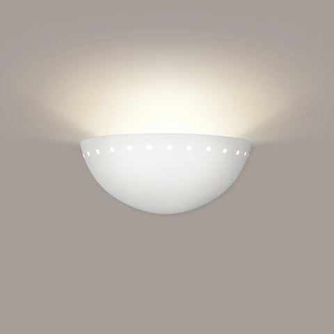 The Modern USA-Made Wall Lighting – Cyprus Sconce by A19 Artisan Lighting is a white, semi-circular fixture with round cutout holes near the rim, mounted on a light gray wall, casting a soft upward glow. Handcrafted in California.