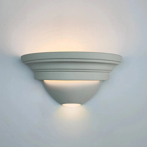 The Formentera Sconce by A19 Artisan Lighting is a modern, USA-made wall light handcrafted in California with a smooth, matte finish. Its rounded design emits soft up and down lighting and is compatible with LED smart bulbs.