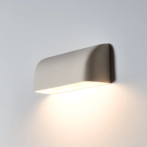 The Gran Balboa Downlight Sconce by A19 Artisan Lighting, handcrafted in California, features smooth, rounded edges and a minimalist design. This USA-made wall light emits a soft, warm LED glow downward for efficient modern style.
