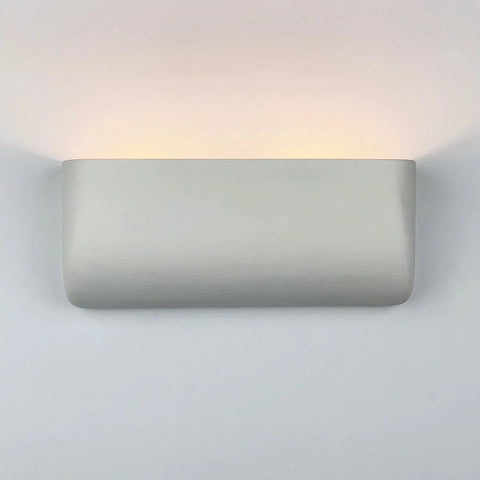 The Modern USA-Made Wall Lighting – Gran Balboa Sconce by A19 Artisan Lighting is handcrafted in California, featuring a smooth ceramic rectangular design and energy-efficient LED illumination that emits a soft upward glow.