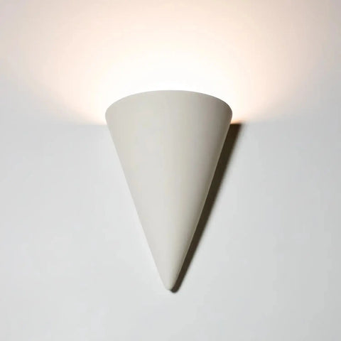 A cone-shaped white Icelandia Sconce wall light mounted on a wall, emitting an uplight pattern.