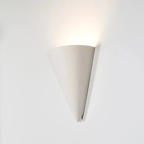The Modern USA-Made Wall Lighting – Icelandia Sconce by A19 Artisan Lighting features a smooth, matte white cone design that casts soft upward light; handcrafted in California and compatible with LED smart bulbs for customizable illumination.