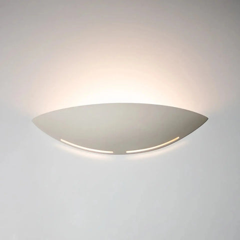 The Kauai Sconce by A19 Artisan Lighting is a modern, white, USA-made wall light handcrafted in California that emits a soft glow upward with LED smart bulbs, creating gentle illumination on any light-colored wall.