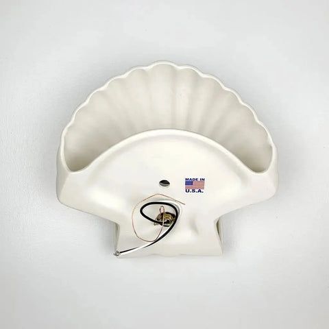 The Key Biscayne Sconce by A19 Artisan Lighting is a white ceramic, shell-shaped wall fixture, handcrafted in California and USA-made—ideal for energy-efficient LED bulbs and shown here against a plain white background.