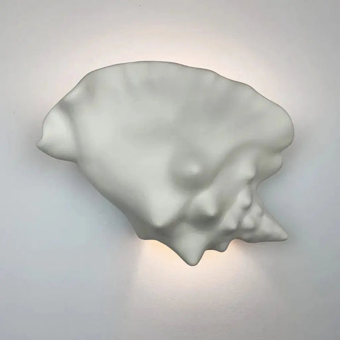 The Modern USA-Made Wall Lighting – Key West Sconce by A19 Artisan Lighting is a white ceramic, seashell-shaped fixture handcrafted in California, LED Smart Bulb Compatible for effortless ambiance control and a soft, gentle glow.