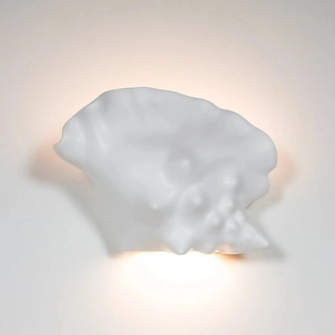 The Modern USA-Made Wall Lighting – Key West Sconce by A19 Artisan Lighting, handcrafted in California, features a white seashell shape that casts a soft, warm glow and is LED Smart Bulb compatible for convenient, efficient ambient lighting.