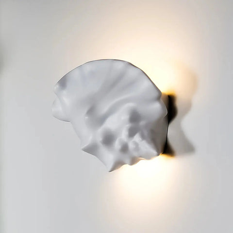 The Key West Sconce by A19 Artisan Lighting is a white ceramic, USA-made wall light with an organic, sculptural design. Handcrafted in California, it emits a warm glow and soft shadows and is compatible with LED Smart Bulbs for modern convenience.