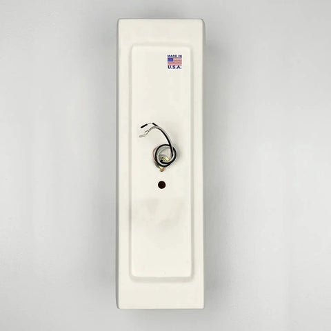 The Kos Sconce by A19 Artisan Lighting is a handcrafted, rectangular white metal wall panel with a central circular hole and exposed wiring—ideal for flush wall lights or LED bulbs. Features a Made in U.S.A. sticker; made in California.