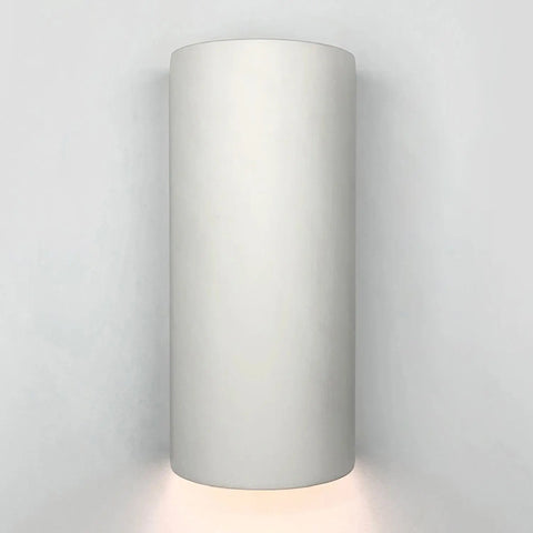 A tall cylinder-shaped flush wall light with a downlight pattern, showing a white finish.
